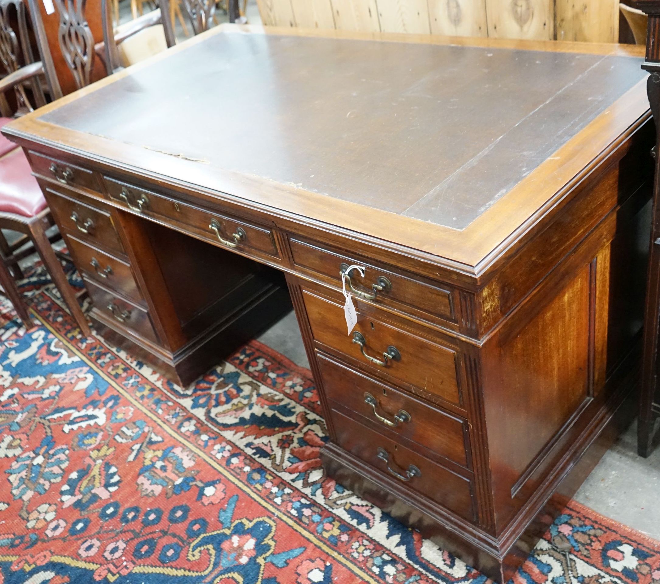 A reproduction Georgian style mahogany twin pedestal desk, fitted nine short drawers, on plinth base, width 152cm, depth 83cm, height 76cm